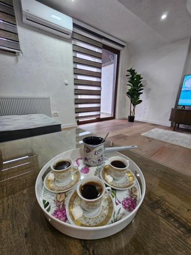 a tray with three cups of coffee on a table at Visoko Luxury Residence in Biskupići