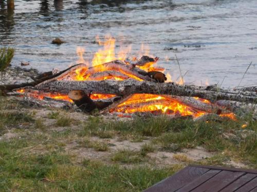a fire in the grass next to a body of water at 4 person holiday home in Haderslev-By Traum in Diernæs