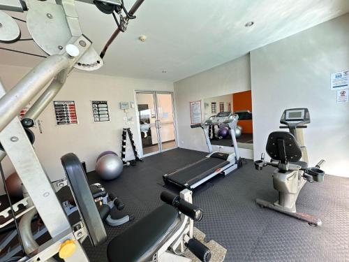 a gym with several treadmills and exercise equipment at 10 minutes to reach the karon beach, with free swimming pool and gym, WIFI in Karon Beach