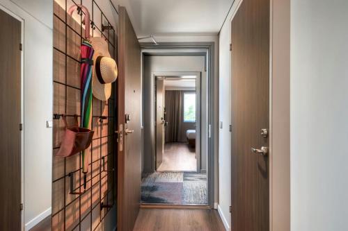 a hallway with a tile wall with umbrellas at Moxy Verona in Verona