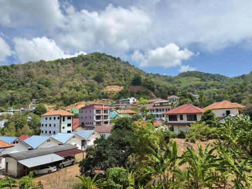 a group of buildings in front of a mountain at 10 minutes to reach the karon beach, with free swimming pool and gym, WIFI in Karon Beach
