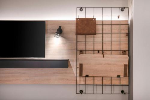 a room with a tv on a wall at Moxy Verona in Verona