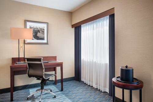 a hotel room with a desk and a chair and a window at Crowne Plaza Hotel Los Angeles Harbor by IHG in San Pedro