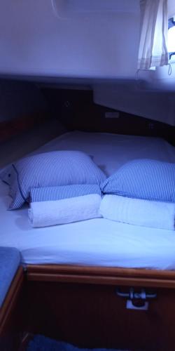 a bed with two pillows on it in a room at Lady Butterfly in Tučepi