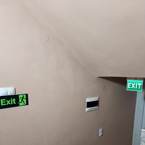 a room with exit signs on a wall at Duba Apartments 2 in Alexandroupoli