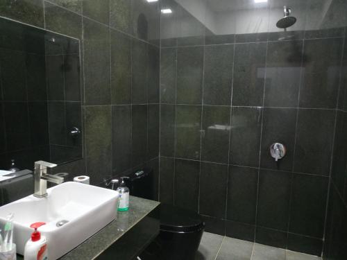 a bathroom with a sink and a shower at Passport Villa in Siem Reap