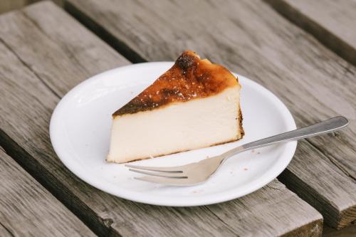 a piece of cake on a plate with a fork at Guesthouse RICO in Wakayama