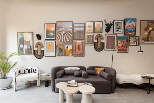 a living room with a couch and pictures on the wall at Prime Residence New Cairo in Cairo