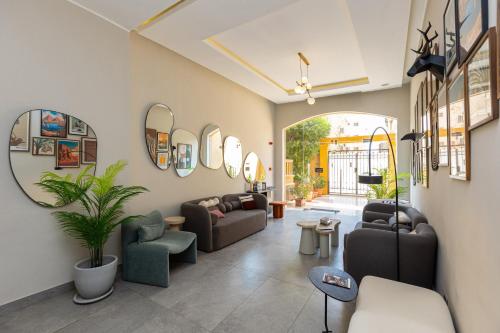 a living room with couches and chairs and mirrors at Prime Residence New Cairo in Cairo