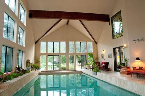a large swimming pool in a large house at Luxurious Mountain Retreat with Pool in Mound City