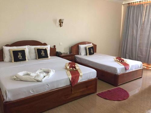 Ένα ή περισσότερα κρεβάτια σε δωμάτιο στο RatanakCity hotel