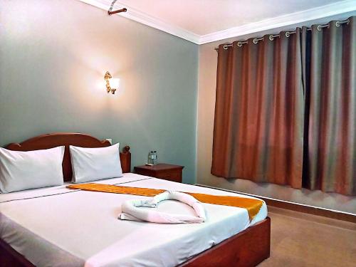 Ένα ή περισσότερα κρεβάτια σε δωμάτιο στο RatanakCity hotel
