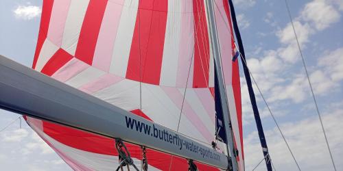 a red white and blue sail on a boat at Lady Butterfly in Tučepi