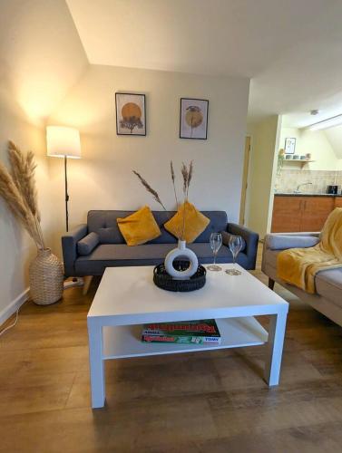 a living room with a white coffee table and a couch at Modern 2-Bed in Ipswich - Free Parking & Fast WiFi in Bramford