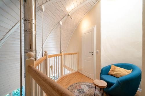 a staircase with a blue chair in a room at Selene in Wustrow