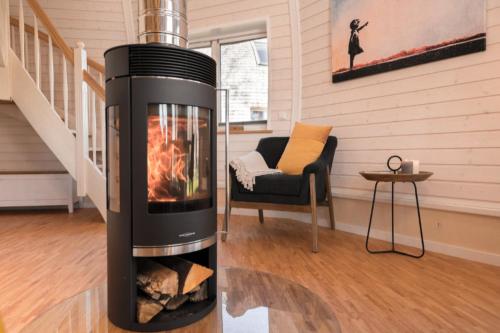a fireplace in the middle of a living room at Selene in Wustrow