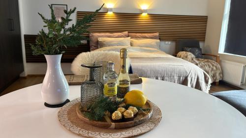 a table with a tray of food and bottles of wine at Ocean View Suite near Sky Lagoon in Reykjavík