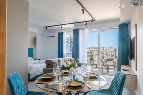 a living room with a table and chairs and a couch at Offshore Suites Apartments in St Julians Centre in St Julian's