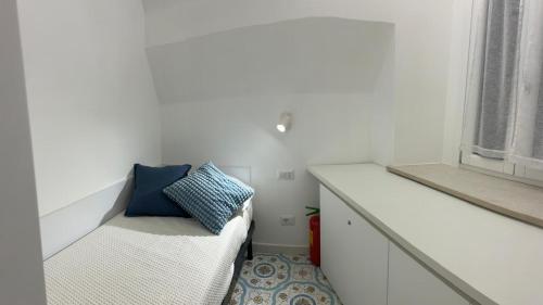 Ένα ή περισσότερα κρεβάτια σε δωμάτιο στο Casa Turchese Amalfi