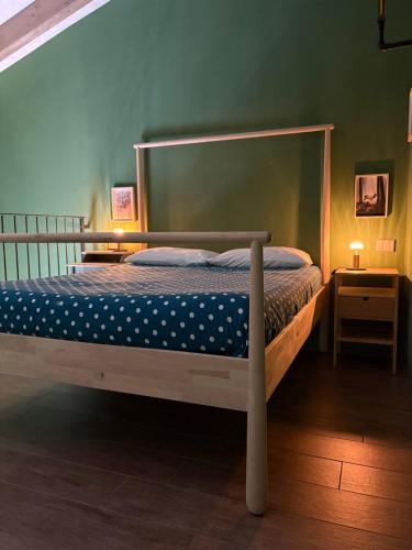a bedroom with a bed with a metal frame at Sala dell Estate Guest House in Secchia