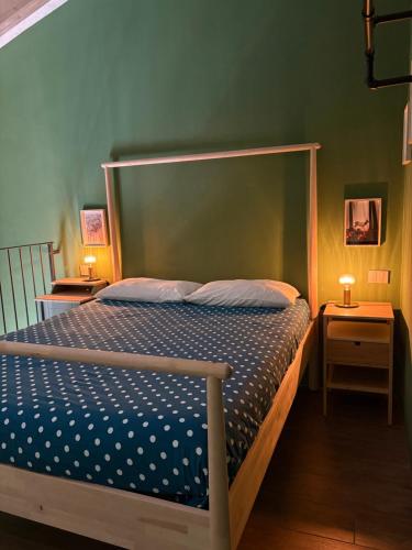 a bedroom with a bed and two night stands at Sala dell Estate Guest House in Secchia