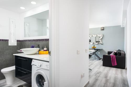 a bathroom with a sink and a washing machine at Beach apartment in Las Americas in Arona