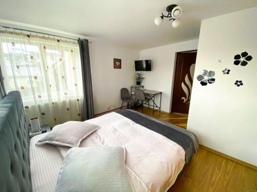 a bedroom with a bed and a window at Casa Irina in Mănăstirea Humorului