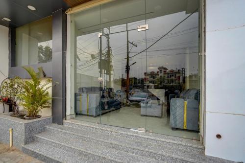 a window of a store with a car in it at Hotel O Red Diamond Hotel in Ghaziabad