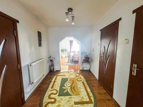 a hallway with a carpet with a snake on it at Casa Irina in Mănăstirea Humorului