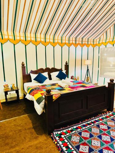 a bedroom with a bed in a tent at Taj heritage camp& resort in Jaisalmer
