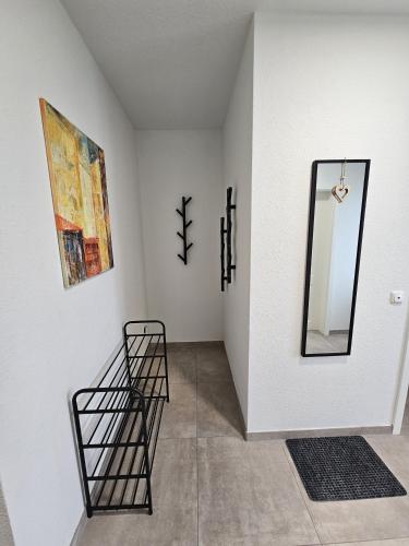 a room with a mirror and a chair on a wall at Wangermeerglück in Wangerland