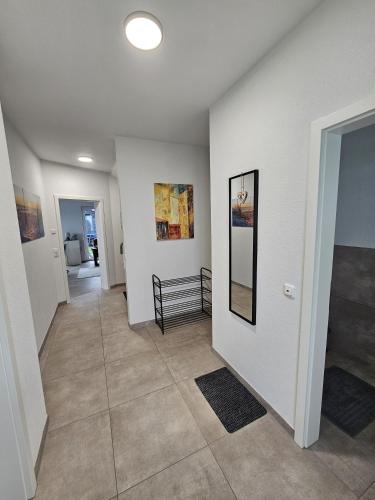 a hallway with white walls and a tile floor at Wangermeerglück in Wangerland