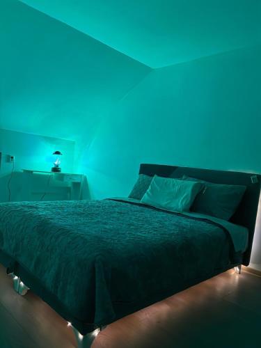 a blue room with a bed with a blue ceiling at Sanlej Apartman in Tuzla