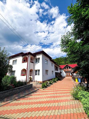 a building with a brick walkway in front of it at Casa Irina in Mănăstirea Humorului