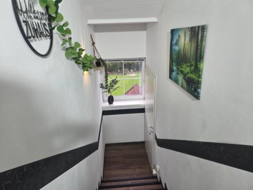 a stairway with a window and a plant at Ferienwohnung Rosi in Sankt Ulrich