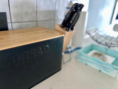 a black box sitting on top of a counter with a knife at Seewindelaan in Scottburgh