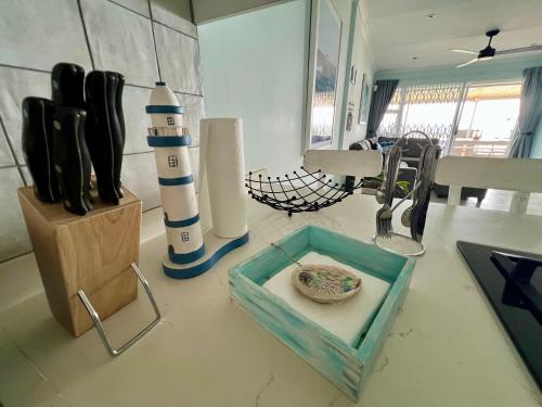 a kitchen counter with a lighthouse and a bowl on a table at Seewindelaan in Scottburgh