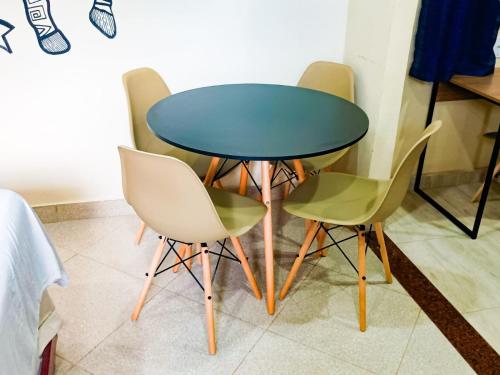 a table and four chairs in a room at Casa Marajoara in Soure