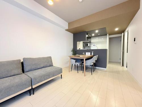 a living room with a couch and a table at Sun Court Nango-dori サンコート南郷通 1003 in Sapporo