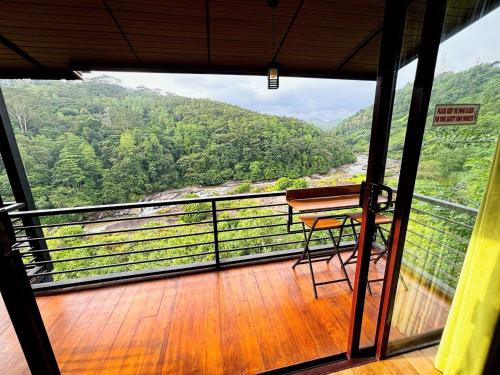 a balcony with a chair and a view of a mountain at Aqua Dunhinda Nature Retreat in Kandy