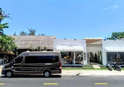 a black van parked in front of a store at Cesar Homestay Phan Thiết in Mui Ne