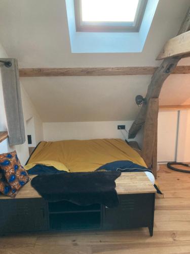 a bedroom with a bed in a room with a window at Maison deux chambres avec grand jardin in Grésy-sur-Aix