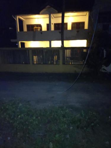 a house at night with a house with a hose at Coconut One in Weligama
