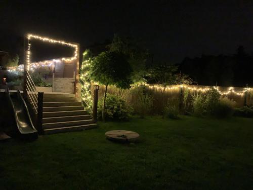 a garden at night with lights on a fence at House Big Win Mělník in Mlazice