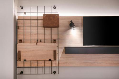 a flat screen tv hanging on a wall at Moxy Verona in Verona