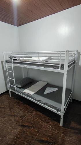 a bunk bed with towels on the bottom bunk at The happy nook in General Santos