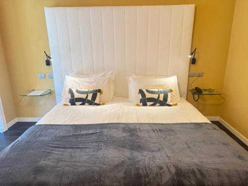 a bedroom with a large bed with two pillows at Greif Hotel & Spa in Trieste