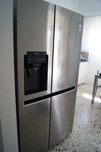 a stainless steel refrigerator in a kitchen at Modernes Ferienhaus in toller Lage in Chrani