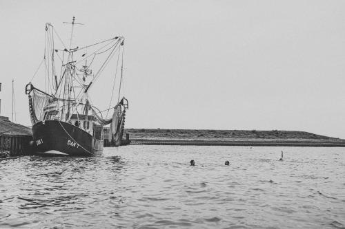 a large boat is docked in the water at Hotel Graf Bentinck in Dangast