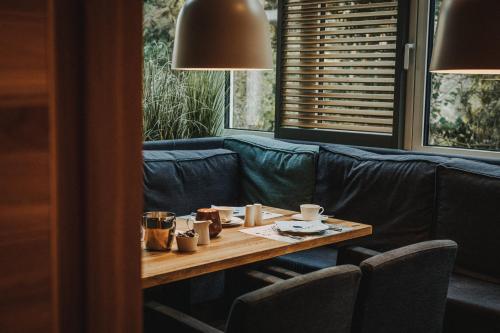 a living room with a table and a couch at Hotel Graf Bentinck in Dangast